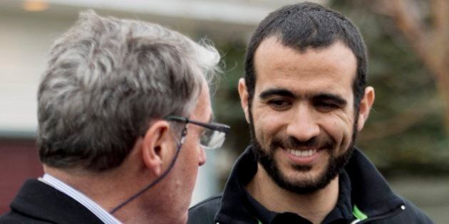 Omar Khadr, right, smiles at his lawyer Dennis Edney, left, as they speak to the media outside his new home after being granted bail in Edmonton on Thursday, May 7, 2015. THE CANADIAN PRESS/Nathan Denette