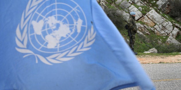 A United Nations flag waves as Spanish U.N. peacekeepers carry out a foot patrol in the disputed Chebaa Farms area between Lebanon and Israel, in southeast Lebanon, Tuesday Feb. 24, 2015. A Spanish peacekeeper was killed in south Lebanon last month during a flare-up in hostilities between Israel and Hezbollah. The U.N. peacekeeping force known as UNIFIL has been deployed in south Lebanon since 1978 and monitors the border between Lebanon and Israel. (AP Photo/Hussein Malla)