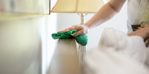 Young woman cleaning surfaces with green cleaning products