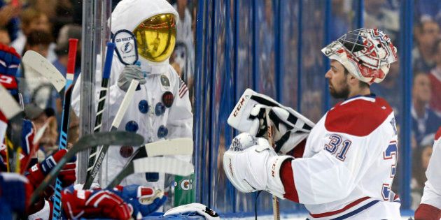 TAMPA, FL - MAY 12: A Tampa Bay Lightning fan dressed as an astronaut cheers in front of Carey Price #31 of the Montreal Canadiens in Game Six of the Eastern Conference Semifinals during the 2015 NHL Stanley Cup Playoffs at Amalie Arena on May 12, 2015 in Tampa, Florida. (Photo by Mike Carlson/Getty Images)