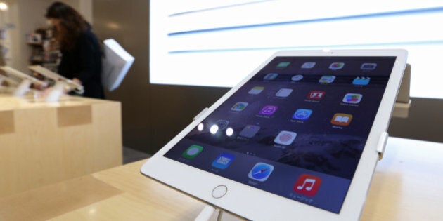 Apple Inc.'s new iPad Air 2 tablet is displayed at a SoftBank Corp. store in the Ginza district of Tokyo, Japan, on Friday, Oct. 24, 2014. Apple last week unveiled refreshed iPads that are thinner and include fingerprint sensors. Photographer: Yuriko Nakao/Bloomberg via Getty Images