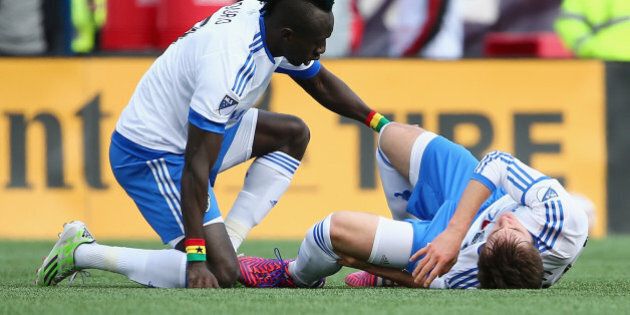 FOXBORO, MA - MARCH 21: Hassoun Camara #6 of Montreal Impact comforts Eric Alexander #29 after he was injured during the first half against the New England Revolutionat Gillette Stadium on March 21, 2015 in Foxboro, Massachusetts. (Photo by Maddie Meyer/Getty Images)