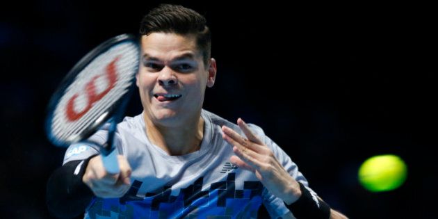 Canadaâs Milos Raonic plays a return to Switzerlandâs Roger Federer during their ATP World Tour Finals tennis match at the O2 Arena in London, Sunday, Nov. 9, 2014. (AP Photo/Alastair Grant)