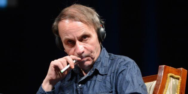 Honorary guest French novelist and poet Michel Houellebecq smokes an electric cigarette during a panel session after he was awarded with the Budapest Grand Prize at the 20th Budapest International Book Festival in Budapest, Hungary, Thursday, April 18, 2013. (AP Photo/MTI, Tamas Kovacs)