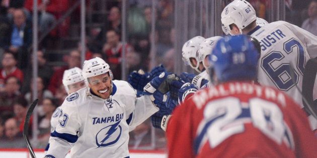 MONTREAL, QC - JANUARY 6: J.T. Brown #23 of the Tampa Bay Lightning celebrates with the bench after scoring a goal against the Montreal Canadiens in the NHL game at the Bell Centre on January 6, 2015 in Montreal, Quebec, Canada. (Photo by Francois Lacasse/NHLI via Getty Images)