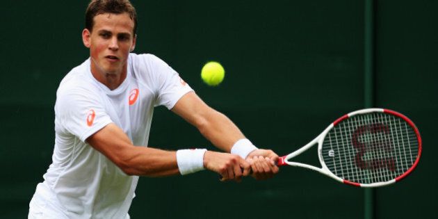 LONDON, ENGLAND - JUNE 23: Vasek Pospisil of Canada in action during his Gentlemen's Singles first round match against Robin Haase of the Netherlands on day one of the Wimbledon Lawn Tennis Championships at the All England Lawn Tennis and Croquet Club at Wimbledon on June 23, 2014 in London, England. (Photo by Steve Bardens/Getty Images)