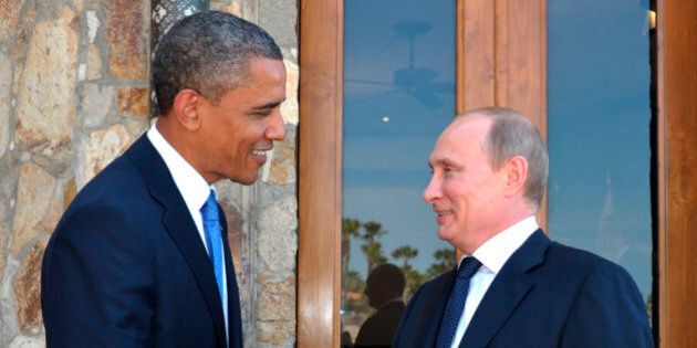 U.S. President Barack Obama, left, greets Russia's President Vladimir Putin at the G-20 Summit in Los Cabos, Mexico, Monday, June 18, 2012. President Barack Obama and Russian President Vladimir Putin huddle on the sidelines of the G-20 meeting in Mexico, in what officials say will be a candid, get-down-to-business meeting about their mutual interests and disagreements. It's their first meeting since Putin returned to Russia's top job. (AP Photo/RIA-Novosti, Alexei Nikolsky, Presidential Press Service)