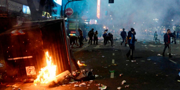 BUENOS AIRES, ARGENTINA - JULY 13: Fans of Argentina clash with riot police after FIFA World Cup final match between Germany and Argentina, at 9 de Julio Avenue on July 13, 2014 in Buenos Aires, Argentina. (Photo by Segundo Saavedra/LatinContent/Getty Images)