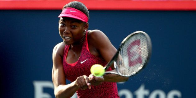 MONTREAL, QC - AUGUST 04: Francoise Abanda of Canada returns a shot to Dominika Cibulkova of Slovakia during the Rogers Cup at Uniprix Stadium on August 4, 2014 in Montreal, Canada. (Photo by Streeter Lecka/Getty Images)