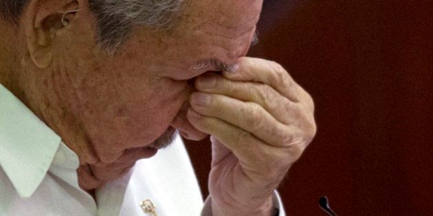 Cuba's President Raul Castro pauses to remove his glasses during his speech to lawmakers at the closing ceremony of the legislative session at the National Assembly in Havana, Cuba, Saturday, Dec. 20, 2014. While praising the historic agreement between Cuba and the U.S. to restore relations, Castro made it clear that the agreement only goes so far, reminding the audience of his call for the U.S. Congress to end the trade embargo. (AP Photo/Ramon Espinosa)