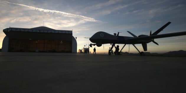 SIERRA VISTA, AZ - MARCH 07: Maintenence personel check a Predator drone operated by U.S. Office of Air and Marine (OAM), before its surveillance flight near the Mexican border on March 7, 2013 from Fort Huachuca in Sierra Vista, Arizona. The OAM, which is part of U.S. Customs and Border Protection, flies the unmanned - and unarmed - MQ-9 Predator B aircraft an average of 12 hours per day at around 19,000 feet over southern Arizona. The drones, piloted from the ground, search for drug smugglers and immigrants crossing illegally from Mexico into the United States. Due to federal sequestration cuts, Customs and Border Protection is expected to lose $500 million from its budget, and OAM staff at Ft. Huachuca are now taking unpaid furlough days once every two weeks. (Photo by John Moore/Getty Images)