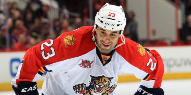 RALEIGH, NC - FEBRUARY 07: Scott Gomez #23 of the Florida Panthers prepares for a faceoff during their NHL game against the Carolina Hurricanes at PNC Arena on February 7, 2014 in Raleigh, North Carolina. (Photo by Gregg Forwerck/NHLI via Getty Images)