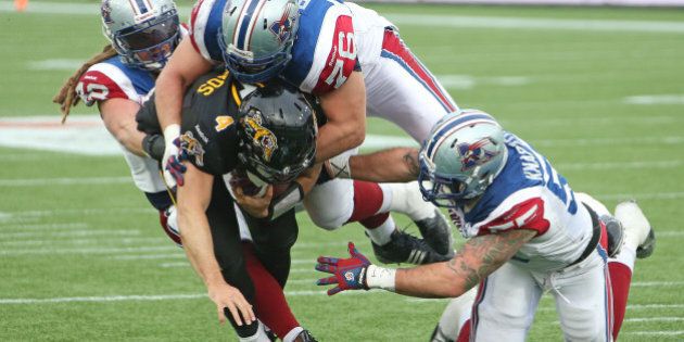 HAMILTON, ON - NOVEMBER 23: Zach Collaros #4 of the Hamilton Tiger-Cats is brought down short of the goal line against the Montreal Alouettes during the CFL football Eastern Conference Final at Tim Hortons Field on November 23, 2014 in Hamilton, Ontario, Canada. The Tiger-Cats defeated the Alouettes 40-24. (Photo by Claus Andersen/Getty Images)