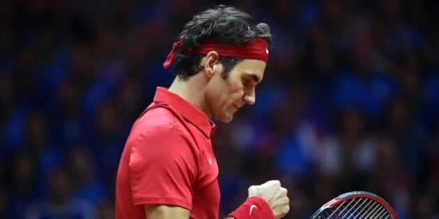 Switzerland's Roger Federer reacts after gaining a point against France's Richard Gasquet during their tennis match at the Davis Cup final between France and Switzerland at Stade Pierre Mauroy in Villeneuve-d'Ascq, northern France, on November 23, 2014. AFP PHOTO / PHILIPPE HUGUEN (Photo credit should read PHILIPPE HUGUEN/AFP/Getty Images)