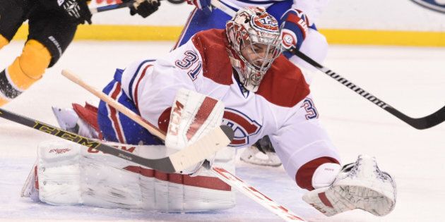 BOSTON, MA - NOVEMBER 22 : Carey Price #31 of the Montreal Canadiens dives on the puck against the Boston Bruins at the TD Garden on November 22, 2014 in Boston, Massachusetts. (Photo by Steve Babineau/NHLI via Getty Images)