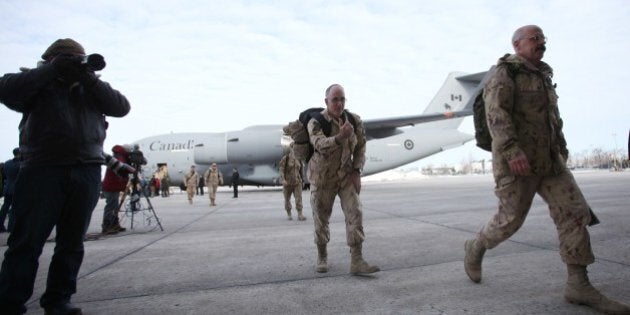 The last Canadian troops to leave Afghanistan, deplane as they return to Canadian soil, in Ottawa, Ontario on March 18, 2014. The last Canadian troops deployed to Afghanistan returned home on Tuesday, bringing an end to Canada's longest ever military engagement. AFP PHOTO/ Cole Burston (Photo credit should read Cole Burston/AFP/Getty Images)