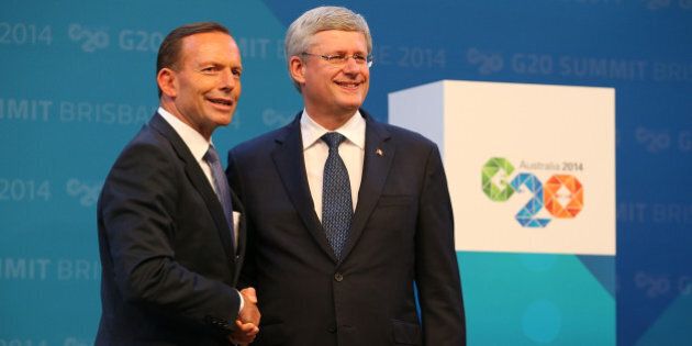 BRISBANE, AUSTRALIA - NOVEMBER 15: Australian Prime Minister Tony Abbott greets Canada's Prime Minister Stephen Harper during the official welcome at the Brisbane Convention and Exhibitions Centre on November 15, 2014 in Brisbane, Australia. World leaders have gathered in Brisbane for the annual G20 Summit and are expected to discuss economic growth, free trade and climate change as well as pressing issues including the situation in Ukraine and the Ebola crisis. (Photo by Chris Hyde/Getty Images)