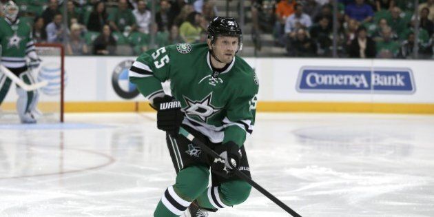 Dallas Stars defenseman Sergei Gonchar (55) of Russia handles the puck during an NHL hockey game against the Florida Panthers, Thursday, Oct. 3, 2013, in Dallas. (AP Photo/Tony Gutierrez))