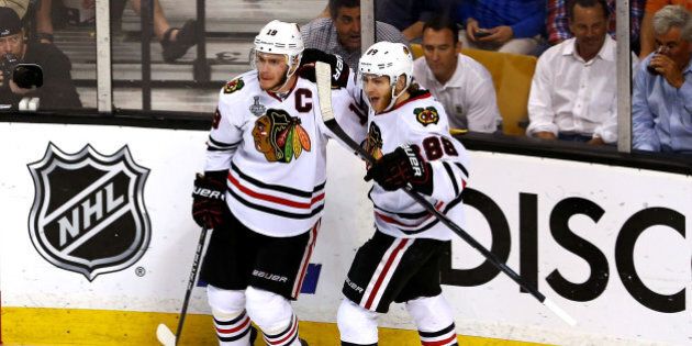 BOSTON, MA - JUNE 24: Jonathan Toews #19 of the Chicago Blackhawks celebrates with teammate Patrick Kane #88 after Toews scored a goal in the second period against Tuukka Rask #40 of the Boston Bruins in Game Six of the 2013 NHL Stanley Cup Final at TD Garden on June 24, 2013 in Boston, Massachusetts. (Photo by Elsa/Getty Images)