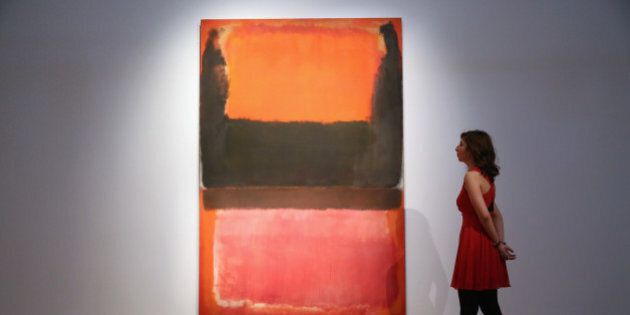 LONDON, ENGLAND - OCTOBER 10: An employee poses next to a painting by Mark Rothko entitled 'Red, Brown, Black and Orange'. Due to be auctioned in New York on November 7th, it is expected to fetch in excess of 50 million USD (31.2 million GBP) (Photo by Carl Court/Getty Images)
