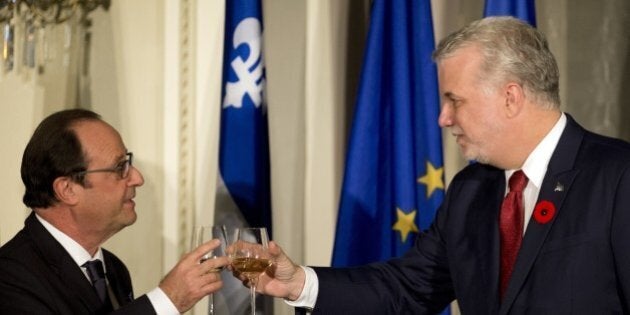 French President Francois Hollande (L) and Quebec Prime Minister Philipe Couillard (R) toast on November 03, 2014 in Quebec, as part of a three-day state visit to Canada. AFP PHOTO/ALAIN JOCARD (Photo credit should read ALAIN JOCARD/AFP/Getty Images)