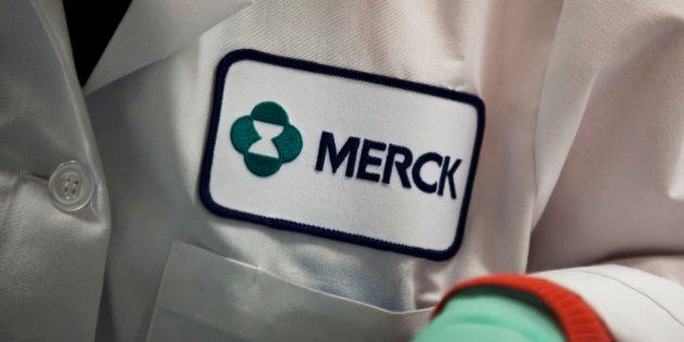 In this Thursday, Feb. 28, 2013 photo, a Merck logo is placed on scientist's lab coat in West Point, Pa. Merck & Co. reports quarterly financial results before the market opens on Wednesday, Feb. 5, 2014. (AP Photo/Matt Rourke)