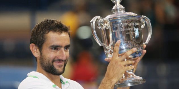 Marin Cilic, of Croatia, holds up the championship trophy after defeating Kei Nishikori, of Japan, in the championship match of the 2014 U.S. Open tennis tournament, Monday, Sept. 8, 2014, in New York. (AP Photo/Mike Groll)
