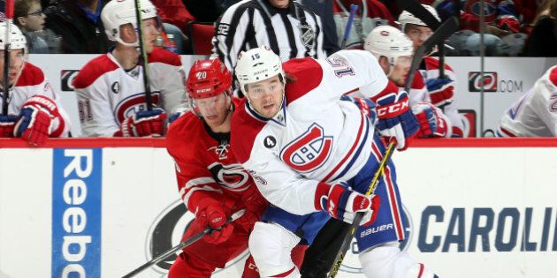 RALEIGH, NC - DECEMBER 29: Riley Nash #20 of the Carolina Hurricanes defends Pierre-Alexandre Parenteau #15 of the Montreal Canadiens as he releases a pass during their NHL game at PNC Arena on December 29, 2014 in Raleigh, North Carolina. (Photo by Gregg Forwerck/NHLI via Getty Images)