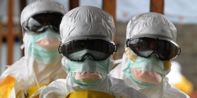 Health care workers, wearing protective suits, leave a high-risk area at the French NGO Medecins Sans Frontieres (Doctors without borders) Elwa hospital on August 30, 2014 in Monrovia. Liberia has been hardest-hit by the Ebola virus raging through west Africa, with 624 deaths and 1,082 cases since the start of the year. AFP PHOTO / DOMINIQUE FAGET (Photo credit should read DOMINIQUE FAGET/AFP/Getty Images)