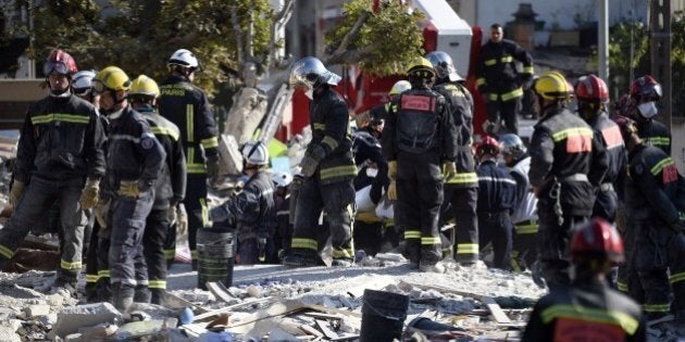 Firefighters search the rubble of a four-storey residential building which collapsed following a blast on September 01, 2014 in Rosny-sous-Bois in the eastern suburbs of Paris. A four-storey residential building collapsed in a Paris suburb following an explosion possibly due to a gas leak, killing at least seven people, local emergency services said. Eleven people were also wounded, including four in serious condition, while 11 others are still unaccounted for. AFP PHOTO / MARTIN BUREAU (Photo credit should read MARTIN BUREAU/AFP/Getty Images)