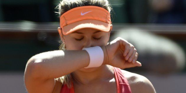 Canada's Eugenie Bouchard reacts after a point during her French tennis Open semi-final match against Russia's Maria Sharapova at the Roland Garros stadium in Paris on June 5, 2014. AFP PHOTO / PASCAL GUYOT (Photo credit should read PASCAL GUYOT/AFP/Getty Images)