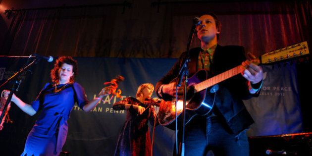 LOS ANGELES, CA - JANUARY 14: (L-R) Musicians Regine Chassagne, Marika Anthony-Shaw and Win Butler of Arcade Fire perform onstage at the Cinema For Peace event benefitting J/P Haitian Relief Organization in Los Angeles held at Montage Hotel on January 14, 2012 in Los Angeles, California. (Photo by Michael Buckner/Getty Images For J/P Haitian Relief Organization and Cinema For Peace)