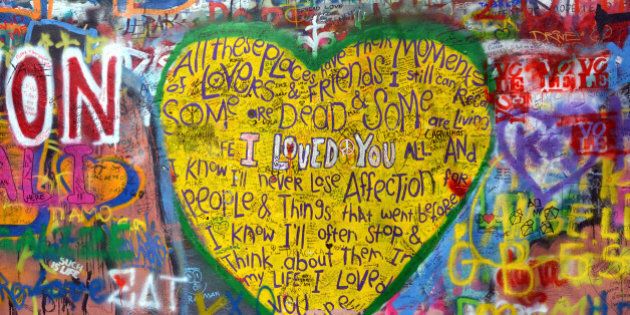 Big Yellow Heart painted by a tourist on John Lennon Wall in Prague. Everyday someone adds new paintings and writings on this wall that is now considered a symbol of global ideals such as peace and love.