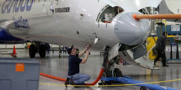 A technician works on an airplane at the Bombardier Inc. production facility in Mirabel, Quebec, Canada, on Thursday, March 7, 2013. The CSeries is Bombardierâs biggest plane ever, and takes aim at the largest part of the global airliner market. Photographer: Patrick Doyle/Bloomberg via Getty Images