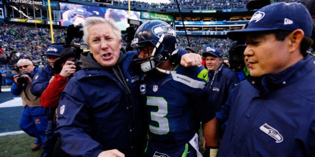 SEATTLE, WA - JANUARY 18: Head coach Pete Carroll celebrates with Russell Wilson #3 of the Seattle Seahawks after the 2015 NFC Championship game against the Green Bay Packers at CenturyLink Field on January 18, 2015 in Seattle, Washington. (Photo by Kevin C. Cox/Getty Images)