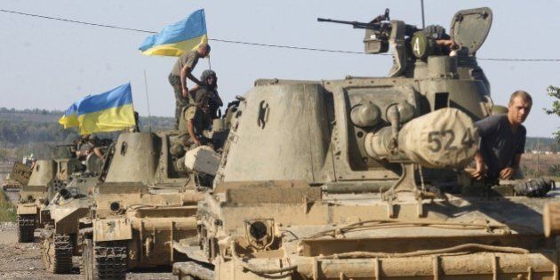 A column of Ukrainian tanks travels in Donetsk region on September 3, 2014. Beleaguered Ukrainian President Petro Poroshenko announced on September 3 that he and his Russian counterpart Vladimir Putin had agreed a surprise truce in Ukraine's four-month war with pro-Moscow rebels. But the Kremlin immediately denied any formal agreement and stressed that Russia played no role in the conflict despite Western claims that it has orchestrated the insurgency tearing apart the ex-Soviet state. AFP PHOTO / ANATOLII STEPANOV (Photo credit should read ANATOLII STEPANOV/AFP/Getty Images)