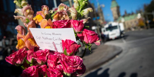 OTTAWA, ON - OCTOBER 23: Flowers are left in memorial for Cpl. Nathan Cirillo of the Canadian Army Reserves, who was killed yesterday while standing guard in front of the National War Memorial by a lone gunman, on October 23, 2014 in Ottawa, Canada. After killing Cirillo the gunman stormed the main parliament building, terrorizing the public and politicians, before he was shot dead. (Photo by Andrew Burton/Getty Images)