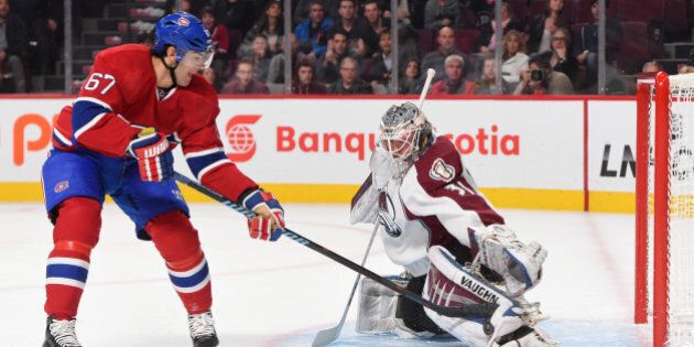 MONTREAL, QC - OCTOBER 18: Calvin Pickard #31 of the Colorado Avalanche makes a kick save after a shot of Max Pacioretty #67 of the Montreal Canadiens in the NHL game at the Bell Centre on October 18, 2014 in Montreal, Quebec, Canada. (Photo by Francois Lacasse/NHLI via Getty Images)
