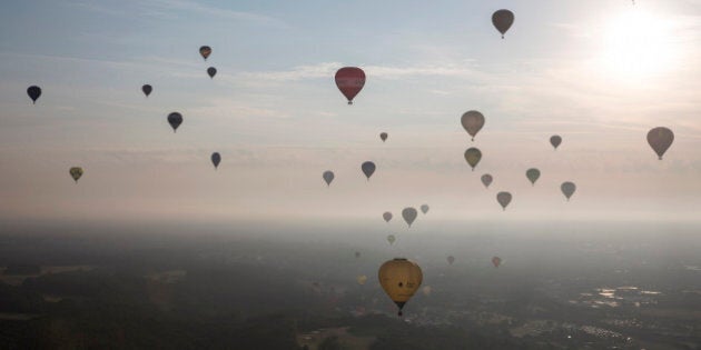 BRISTOL, ENGLAND - AUGUST 08: Hot air balloons depart from Aston Court in a mass ascent on the first full day of the Bristol International Balloon Fiesta on August 8, 2014 in Bristol, England. Now in its 36th year, the Fiesta is Europe's largest annual hot air balloon event in the city that is seen by many as the home of modern ballooning. (Photo by Oli Scarff/Getty Images)