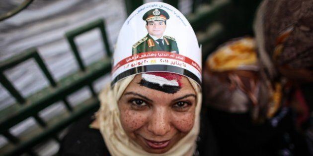 An Egyptian woman with a portrait of ex-army chief Abdel Fattah al-Sisi on her head takes part in celebrations in Cairo's Tahrir Square on June 3, 2014 after Sisi won 96.9 percent of votes in the country's presidential election. Sisi urged his countrymen to work to restore stability and achieve 'freedom' and 'social justice', in a speech after he was declared winner of last week's election. AFP PHOTO / MOHAMED EL-SHAHED (Photo credit should read MOHAMED EL-SHAHED/AFP/Getty Images)
