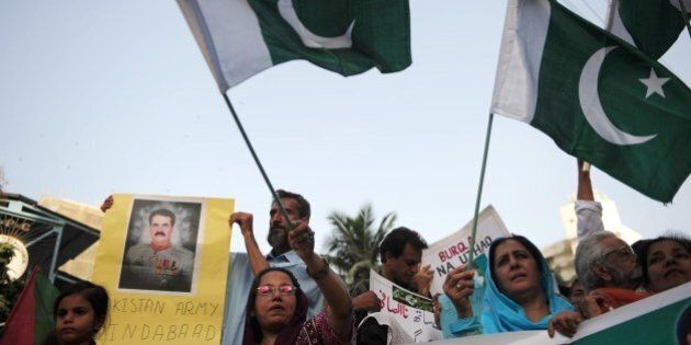 Supporters of Pakistan's former military ruler Pervez Musharraf demonstrate in Karachi on April 27, 2014. Musharraf, facing a battery of criminal cases, must wait a fortnight to learn if he will be given permission to go abroad to visit his sick mother. AFP PHOTO/Asif HASSAN (Photo credit should read ASIF HASSAN/AFP/Getty Images)
