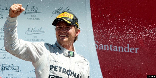 Mercedes' German driver Nico Rosberg celebrates his victory on the podium at the Silverstone circuit...