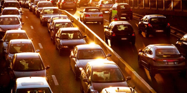 Car traffic against the sunset background.