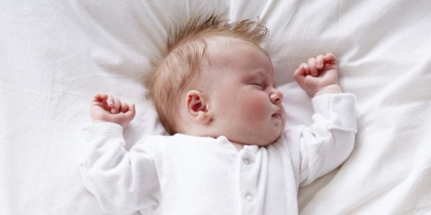 Newborn Baby Girl Sleeping In Bed