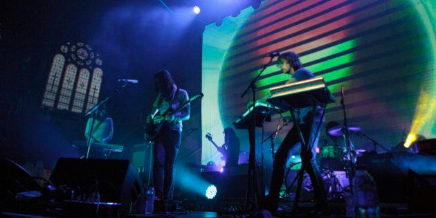 MANCHESTER, UNITED KINGDOM - JULY 12: Dominic Simper, Kevin Parker, Jay Watson and Julien Barbagallo of Tame Impala perform on stage at Albert Hall on July 12, 2014 in Manchester, United Kingdom. (Photo by Andrew Benge/Redferns via Getty Images)