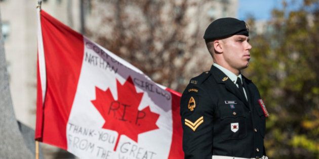OTTAWA, ON - OCTOBER 24: A soldier in the Canadian Army stands guard at the National War Memorial during a ceremony at the memorial on October 24, 2014 in Ottawa, Canada. Two days ago a gunman killed Cpl. Nathan Cirillo, a soldier guarding the memorial. The gunman then stormed the main parliament building, terrorizing the public and politicians, before he was shot dead. (Photo by Andrew Burton/Getty Images)