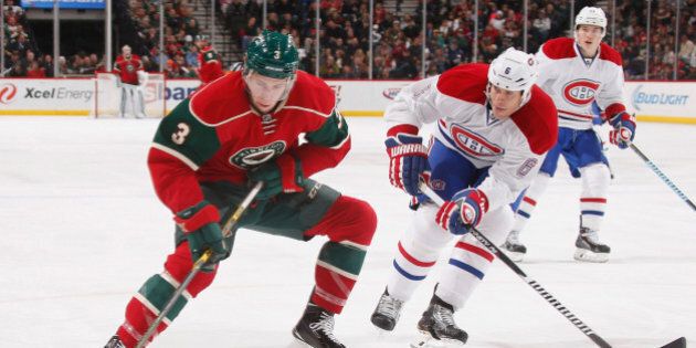 ST. PAUL, MN - DECEMBER 3: Charlie Coyle #3 of the Minnesota Wild handles the puck with Bryan Allen #6 of the Montreal Canadiens defending during the game on December 3, 2014 at the Xcel Energy Center in St. Paul, Minnesota. (Photo by Bruce Kluckhohn/NHLI via Getty Images)