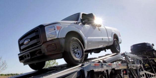 In this March 29, 2011 photo, new 2011 Ford F-250 trucks are delivered to a dealership in Glbert, Ariz. In this March 29, 2011 photo, new 2011 Ford F-150 trucks are shown at a dealership in Glbert, Ariz. Consumer demand for Ford's fuel-efficient vehicles continues to grow as March sales increased 19 percent versus a year ago. (AP Photo/Matt York)