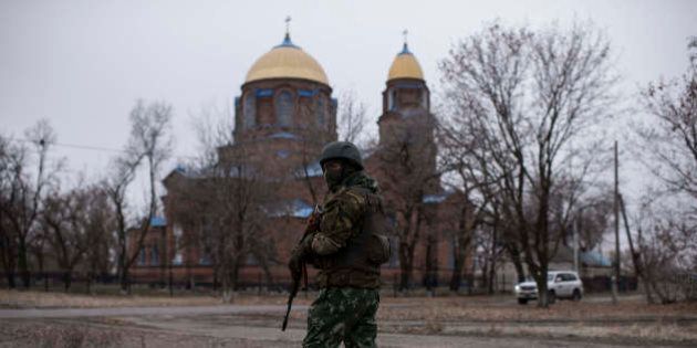 A Ukrainian serviceman patrols the center of Trehizbenka village, controlled by Ukrainian government forces, in Luhansk region eastern Ukraine, Sunday, Nov. 23, 2014. More than 4,300 people have died in fighting in eastern Ukraine over the past half year, according to U.N. estimates. (AP Photo/Evgeniy Maloletka)