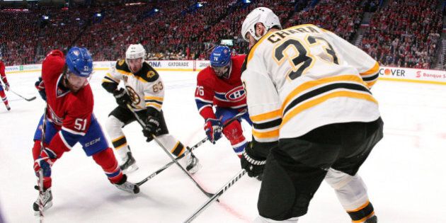 MONTREAL, QC - MAY 8: David Desharnais #51 of the Montreal Canadiens stick handles the puck along the boards as P.K. Subban #76 battles for position against Brad Marchand #63 and Zdeno Chara #33 of the Boston Bruins in Game Four of the Second Round of the 2014 NHL Stanley Cup Playoffs at the Bell Centre on May 8, 2014 in Montreal, Quebec, Canada. (Photo by Francois Laplante/Freestyle Photography/Getty Images)